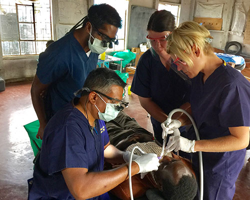 Dentists helping patient 