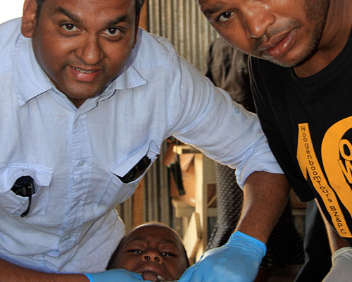 Dentist and man helping patient